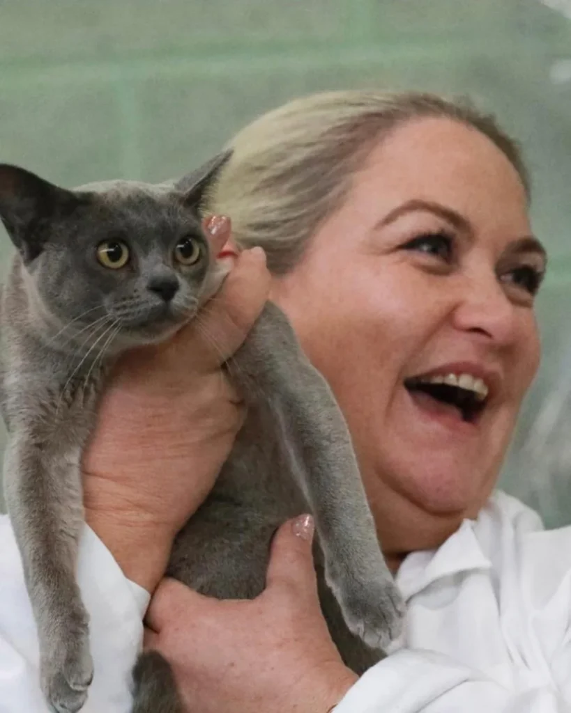 A doctor who is happy and carrying the cat